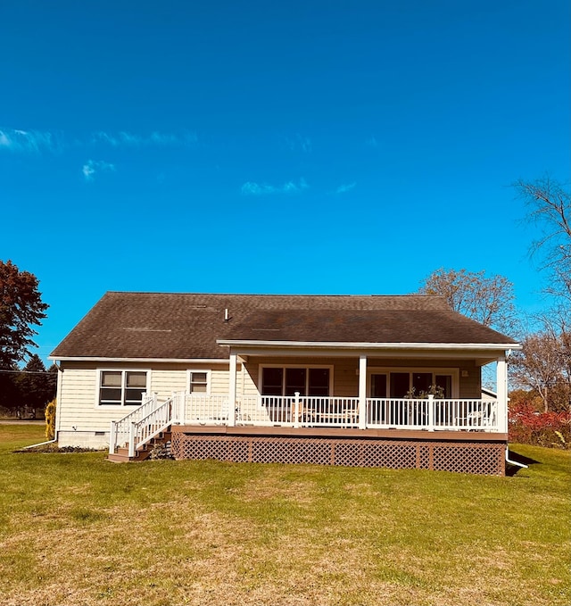 rear view of house with a yard