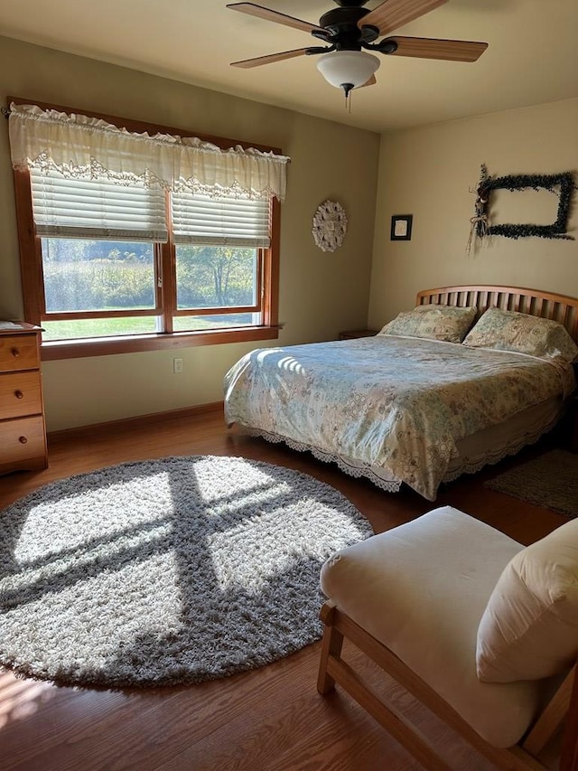 bedroom with hardwood / wood-style floors and ceiling fan