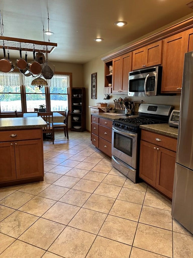 kitchen featuring light tile patterned floors and stainless steel appliances