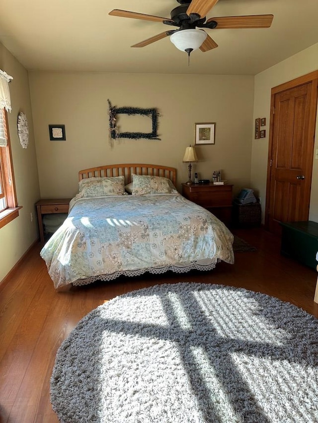 bedroom featuring ceiling fan and hardwood / wood-style flooring