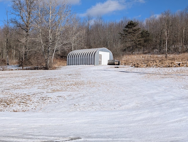 view of yard featuring a detached carport and an outbuilding