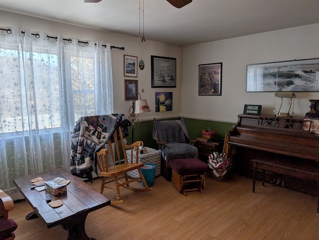 living area featuring light wood-type flooring, ceiling fan, and a wealth of natural light