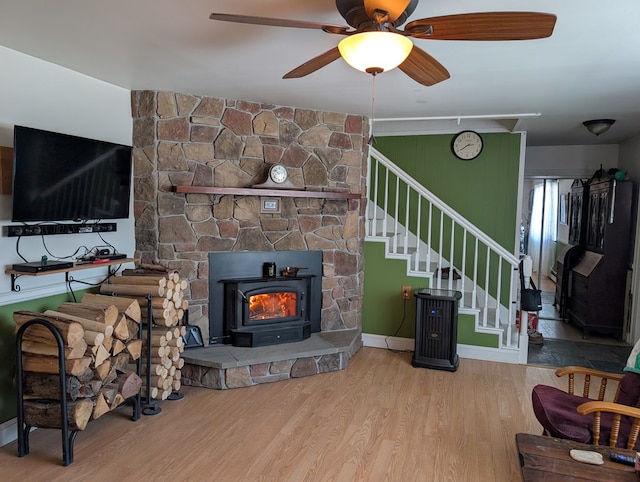 living room featuring light wood-style flooring, stairs, baseboards, and ceiling fan