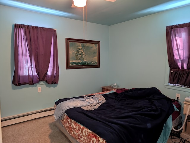 bedroom with a baseboard heating unit and carpet flooring