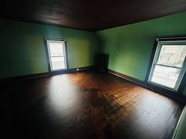 spare room with dark wood-type flooring