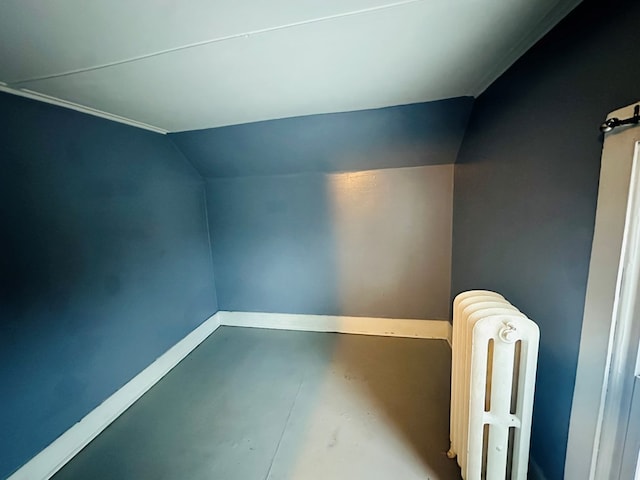 bonus room with radiator heating unit and vaulted ceiling