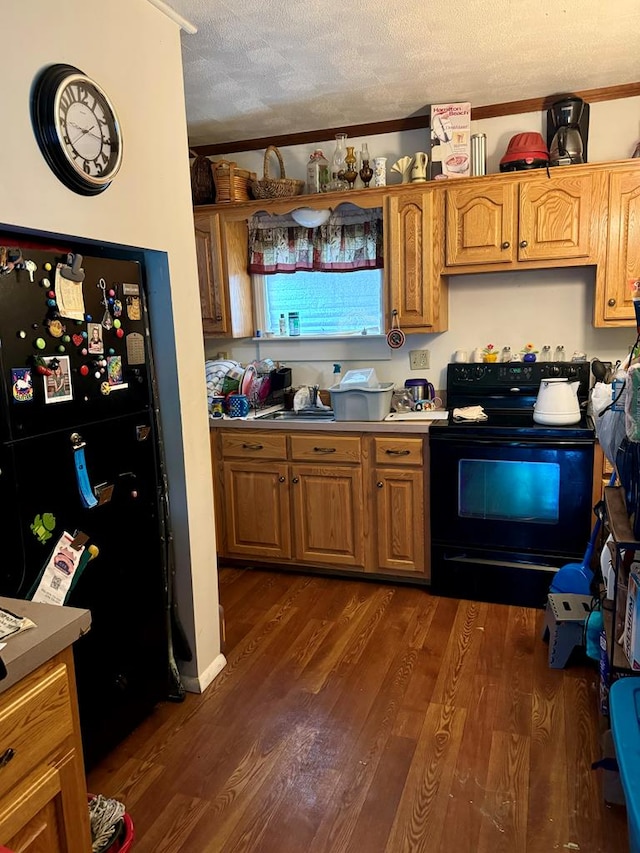 kitchen featuring black appliances, dark hardwood / wood-style flooring, and a textured ceiling