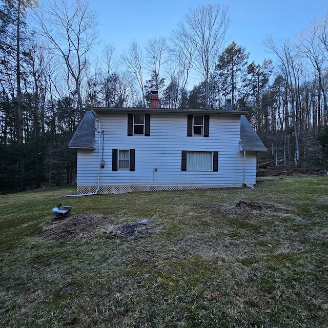 back of house with a lawn