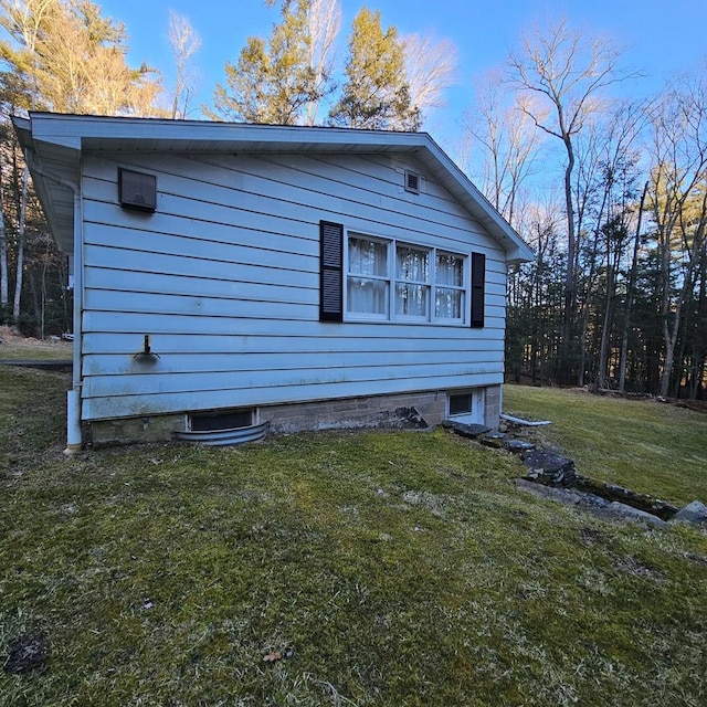 view of side of home featuring a lawn