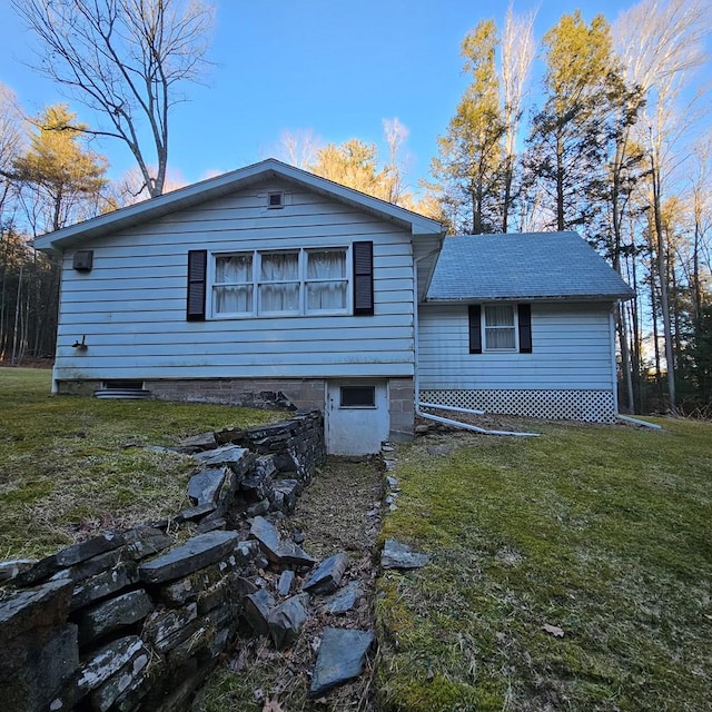 rear view of house with a yard