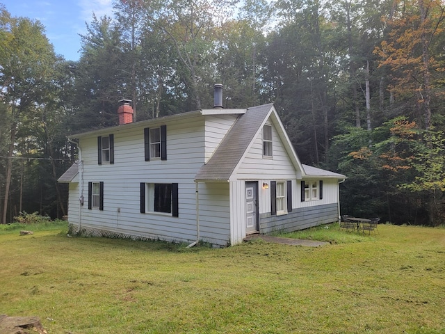 rear view of house with a lawn