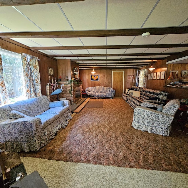 living room with beamed ceiling, carpet flooring, and wooden walls