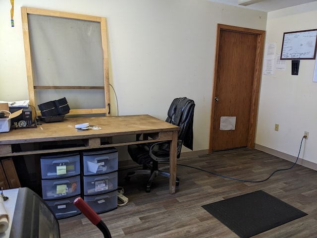 home office with dark hardwood / wood-style flooring