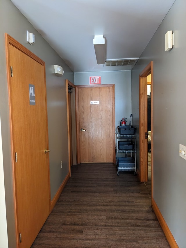 corridor featuring dark hardwood / wood-style floors