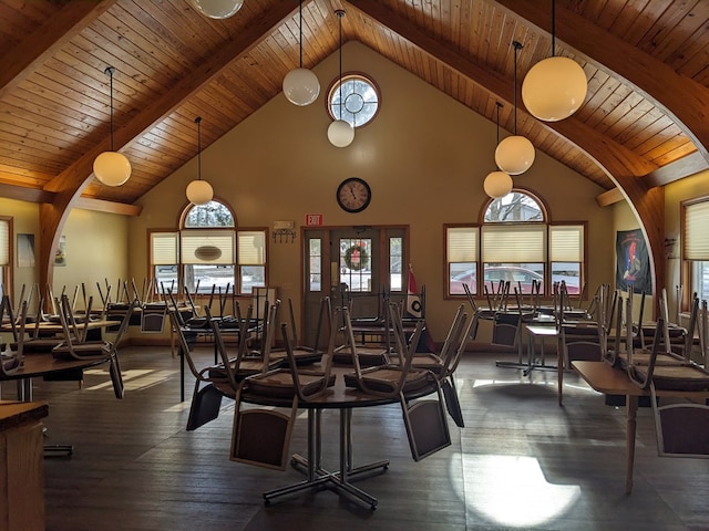 exercise room with high vaulted ceiling and wood ceiling