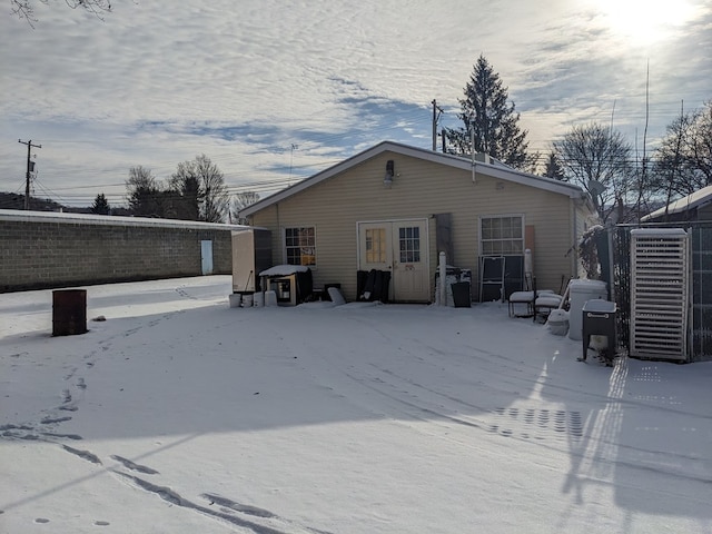 view of snow covered back of property