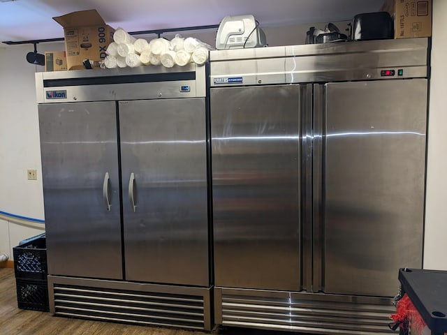 kitchen featuring hardwood / wood-style flooring, stainless steel refrigerator, and built in refrigerator