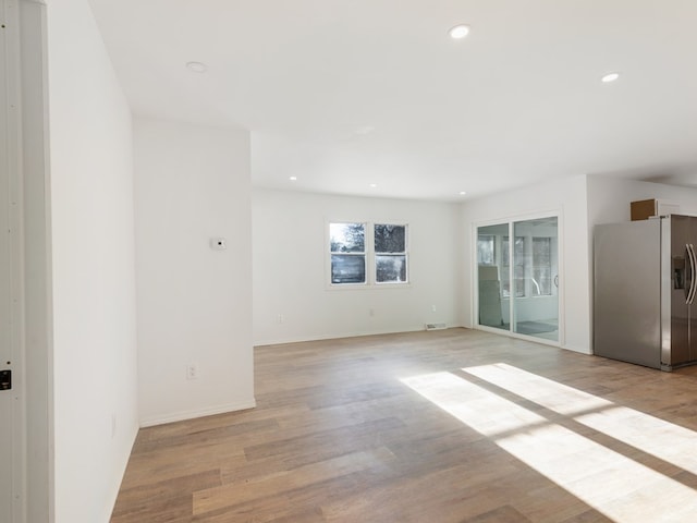 spare room with light hardwood / wood-style floors