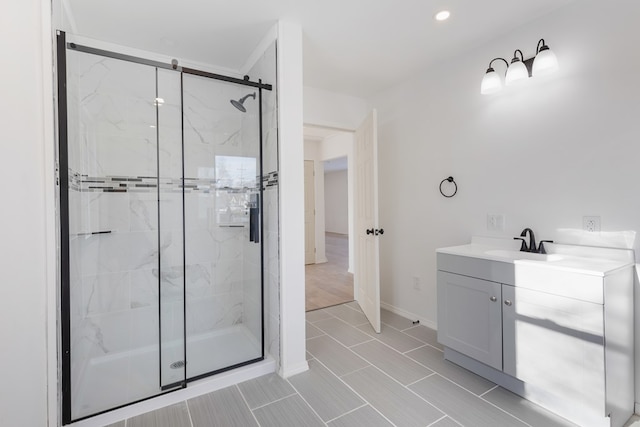 bathroom with tile patterned floors, vanity, and a shower with shower door