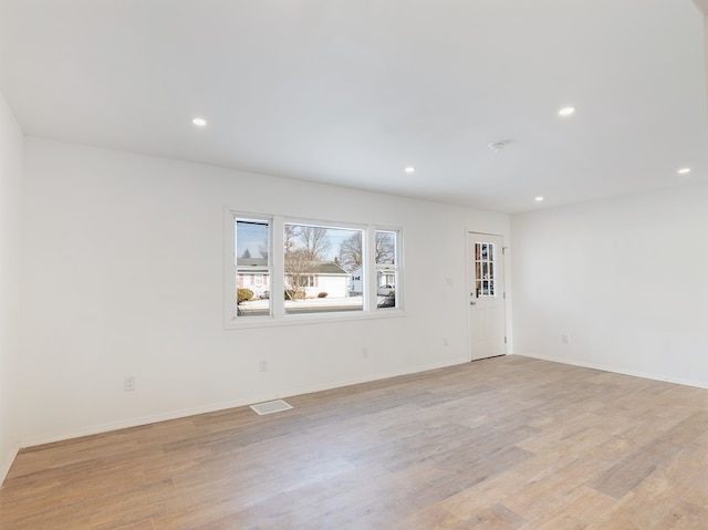 spare room with light hardwood / wood-style floors