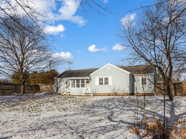 view of snow covered rear of property