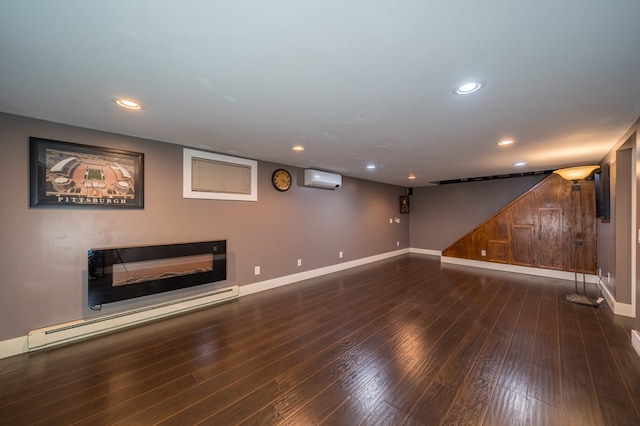 basement featuring an AC wall unit, wood walls, dark hardwood / wood-style floors, and a baseboard heating unit