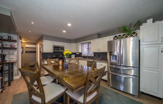 dining room featuring hardwood / wood-style flooring and sink