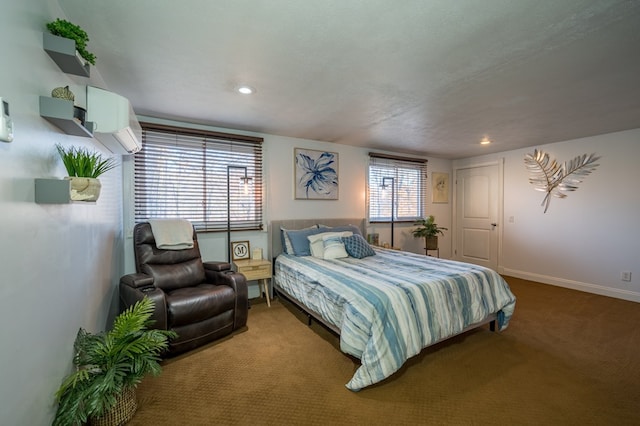 bedroom featuring carpet, a textured ceiling, and a wall mounted AC