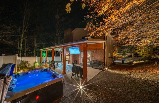 view of pool with a patio and a hot tub