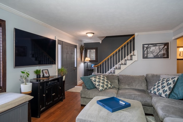 living room featuring dark hardwood / wood-style flooring, ornamental molding, and a textured ceiling