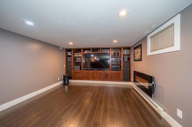 home theater room featuring a fireplace and dark wood-type flooring