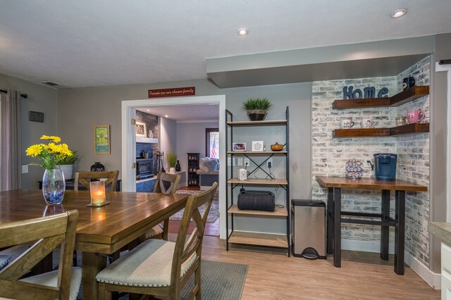 dining room featuring a textured ceiling and light wood-type flooring