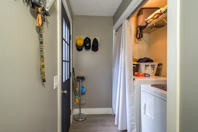 laundry area with wood-type flooring and independent washer and dryer