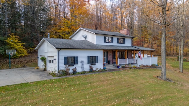 view of front of property with a front lawn, covered porch, and a garage