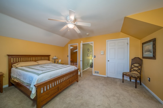 bedroom featuring ceiling fan, lofted ceiling, and light carpet