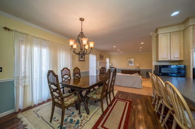 dining space with dark hardwood / wood-style flooring, a notable chandelier, and crown molding