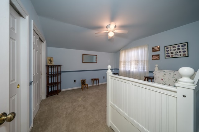 carpeted bedroom with lofted ceiling, a closet, and ceiling fan