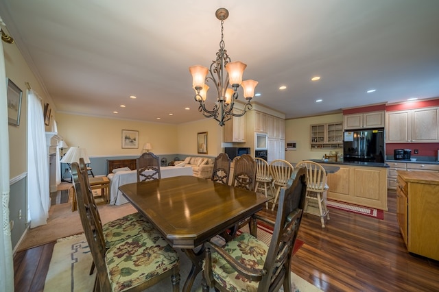 dining area featuring crown molding, dark hardwood / wood-style floors, and a notable chandelier