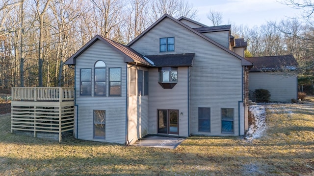 back of property featuring a yard and a deck