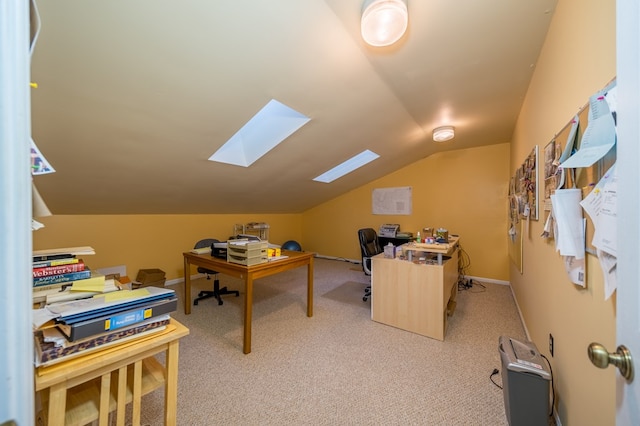 office space with lofted ceiling with skylight and light carpet