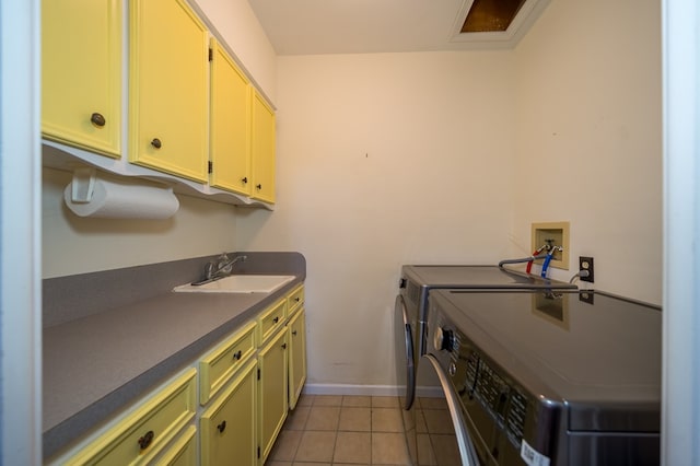 laundry room with independent washer and dryer, cabinets, light tile patterned flooring, and sink