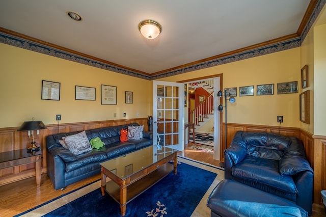 living room featuring french doors, ornamental molding, and hardwood / wood-style floors