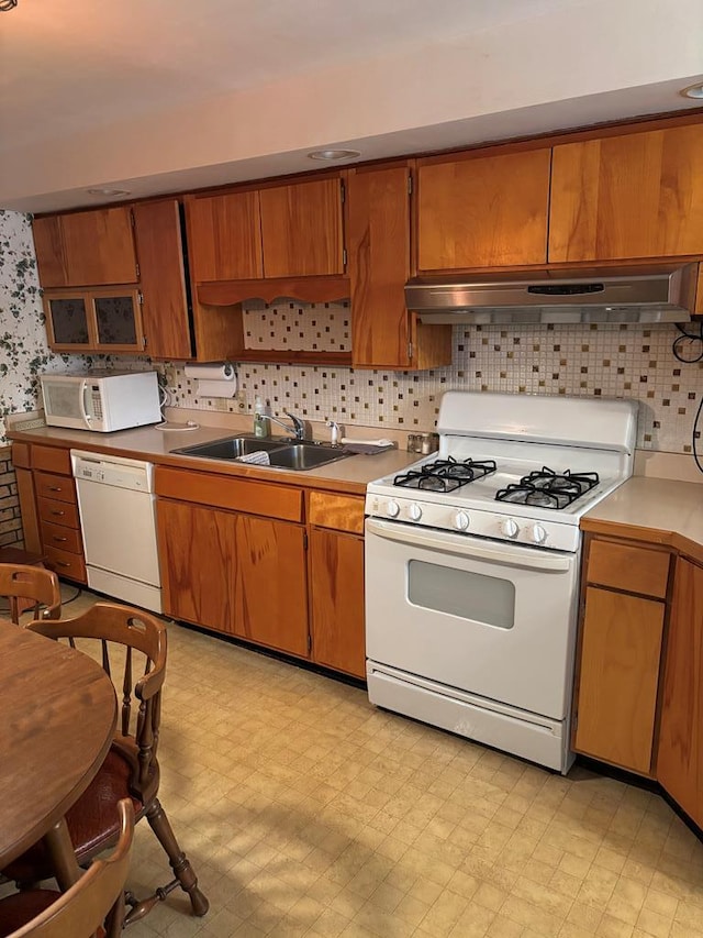 205 E Main St, Elkland, PA 16920 - kitchen featuring a sink, tasteful backsplash, white appliances, light floors, and under cabinet range hood