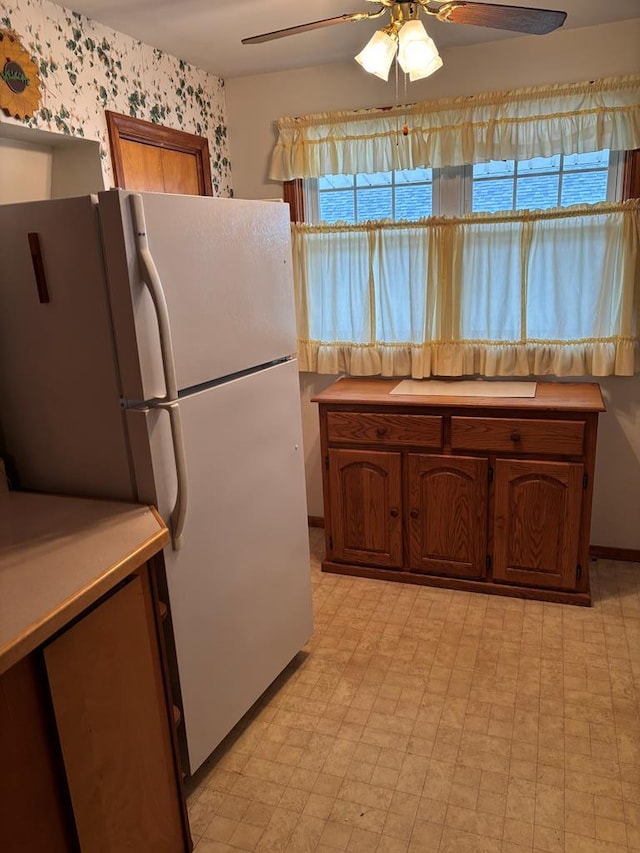 205 E Main St, Elkland, PA 16920 - kitchen featuring a wealth of natural light, a ceiling fan, wallpapered walls, and freestanding refrigerator