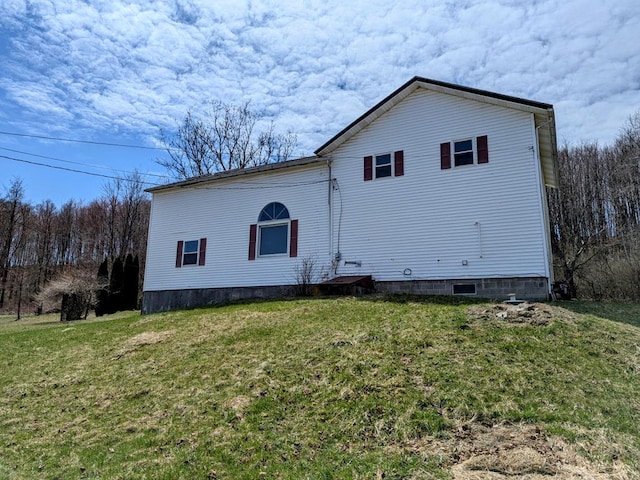 back of property with a lawn
