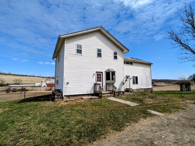 back of property featuring a yard