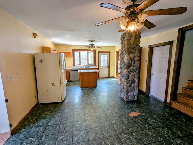 kitchen featuring freestanding refrigerator, stainless steel dishwasher, a ceiling fan, a center island, and light countertops