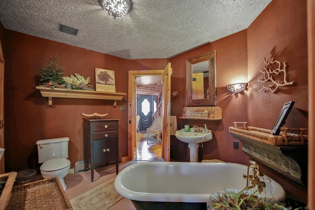 20 Mill Creek Rd, Mansfield, PA 16933 - full bathroom with a soaking tub, toilet, and a textured ceiling