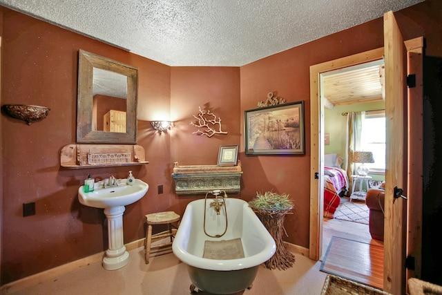 20 Mill Creek Rd, Mansfield, PA 16933 - bathroom featuring a freestanding bath, baseboards, and a textured ceiling