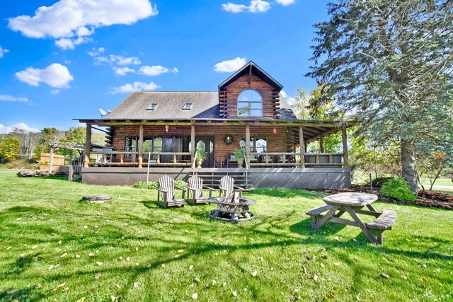 20 Mill Creek Rd, Mansfield, PA 16933 - back of house featuring log exterior, a fire pit, a lawn, and a wooden deck